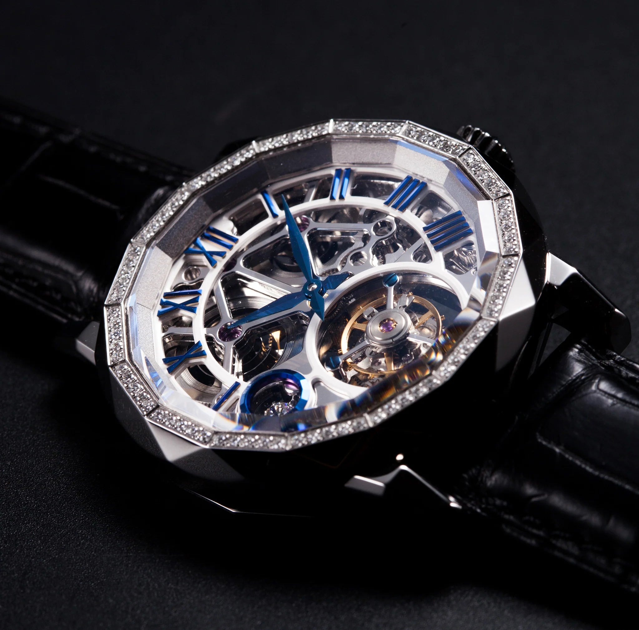 Luxury watch with intricate design and black leather strap on a dark background