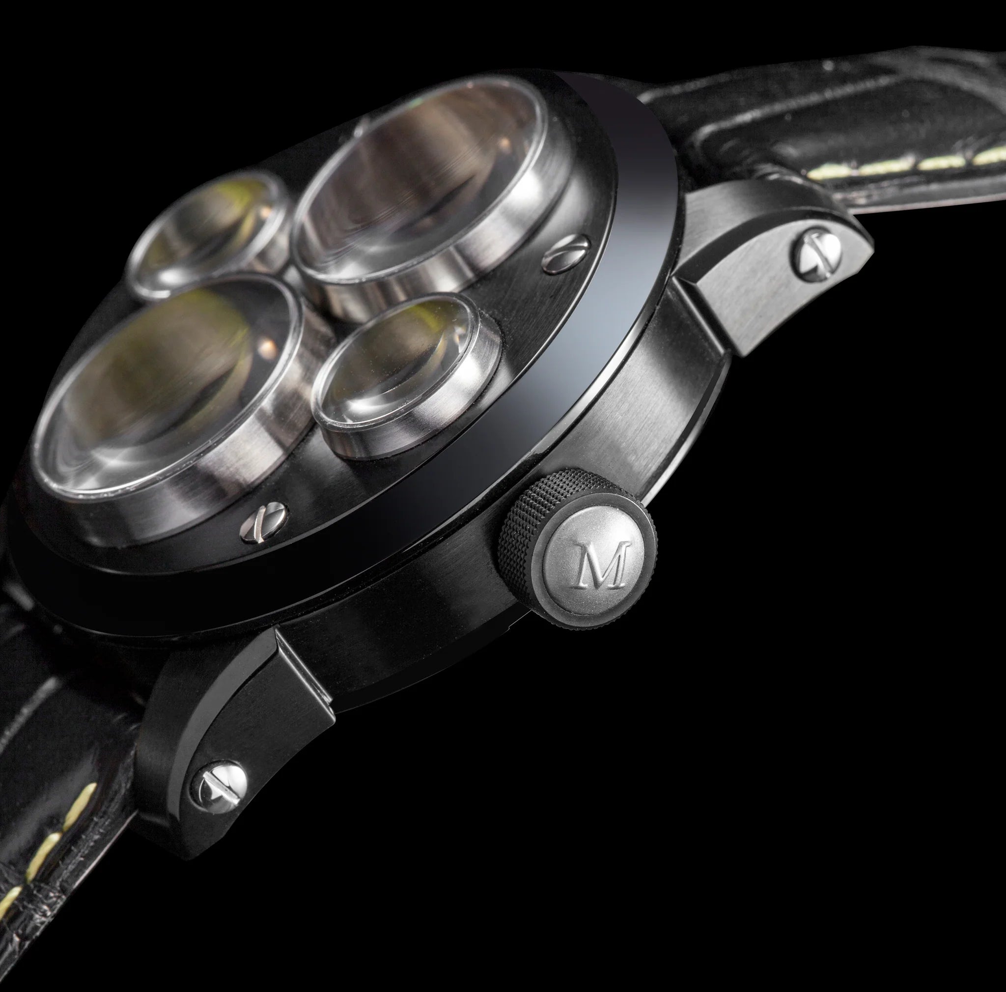 Close-up of a watch with metallic accents and a brand logo on a black background