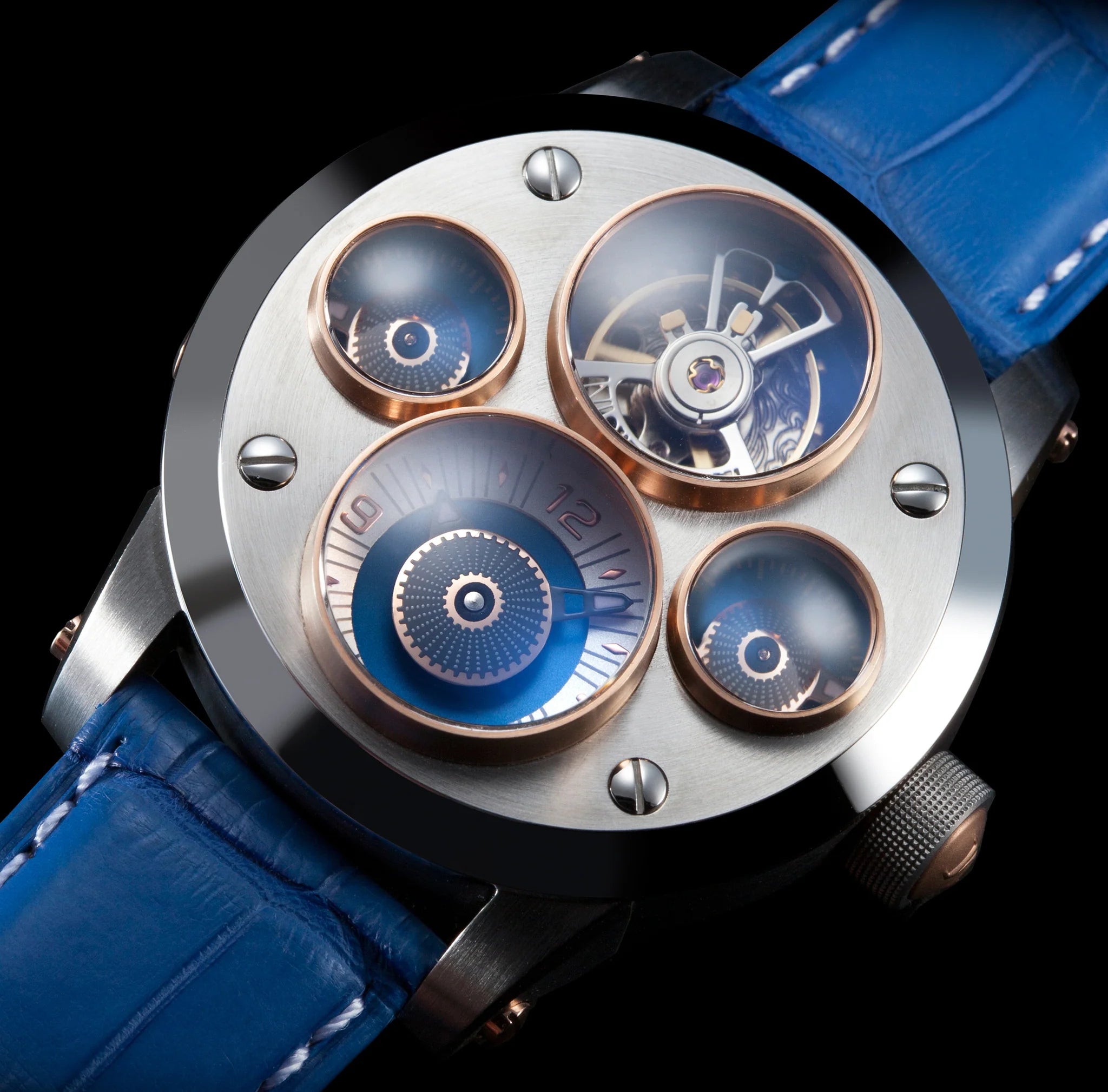Luxury watch with blue leather strap and intricate design on a black background