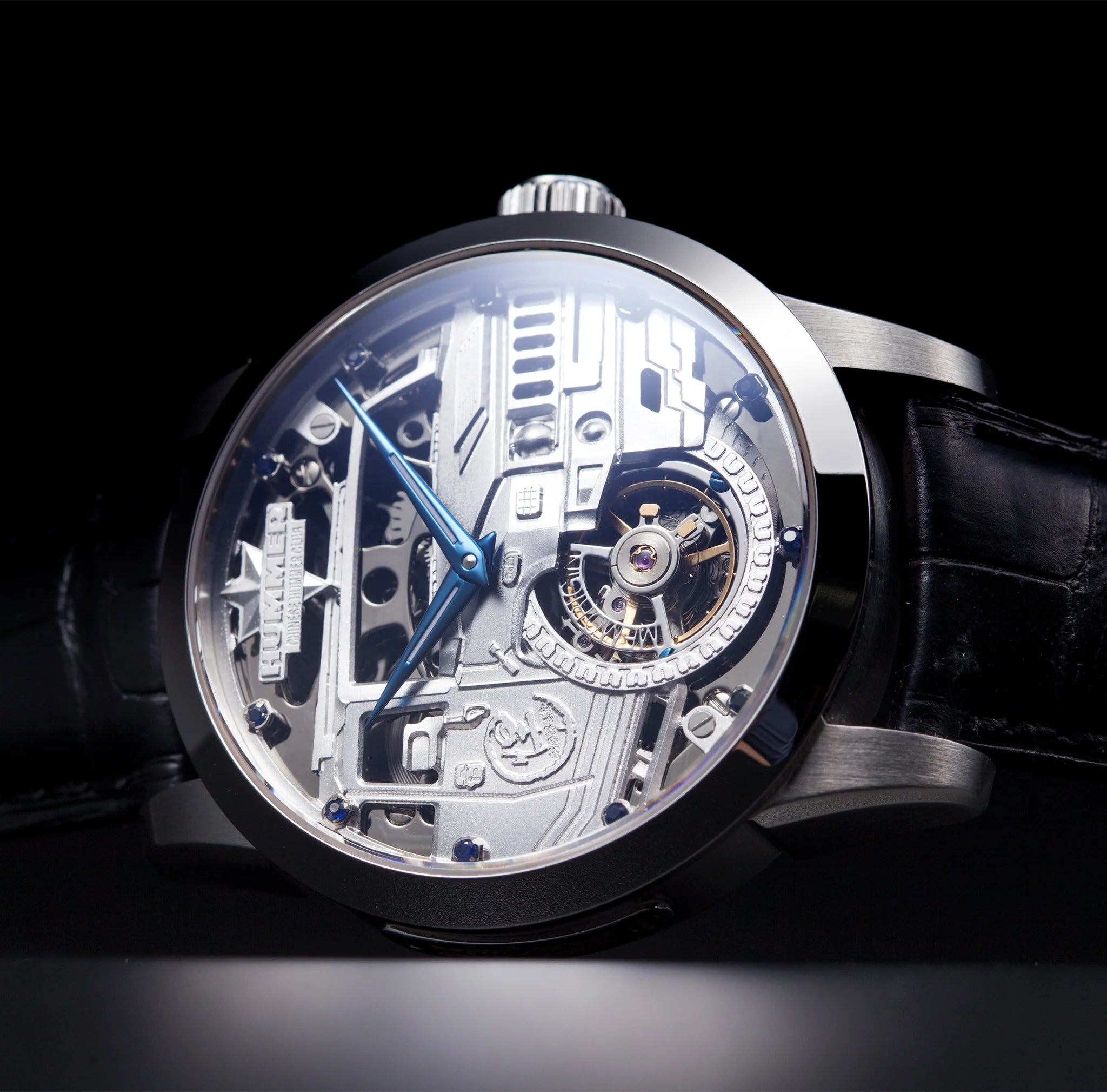 Luxury watch with transparent face and black strap on a dark background