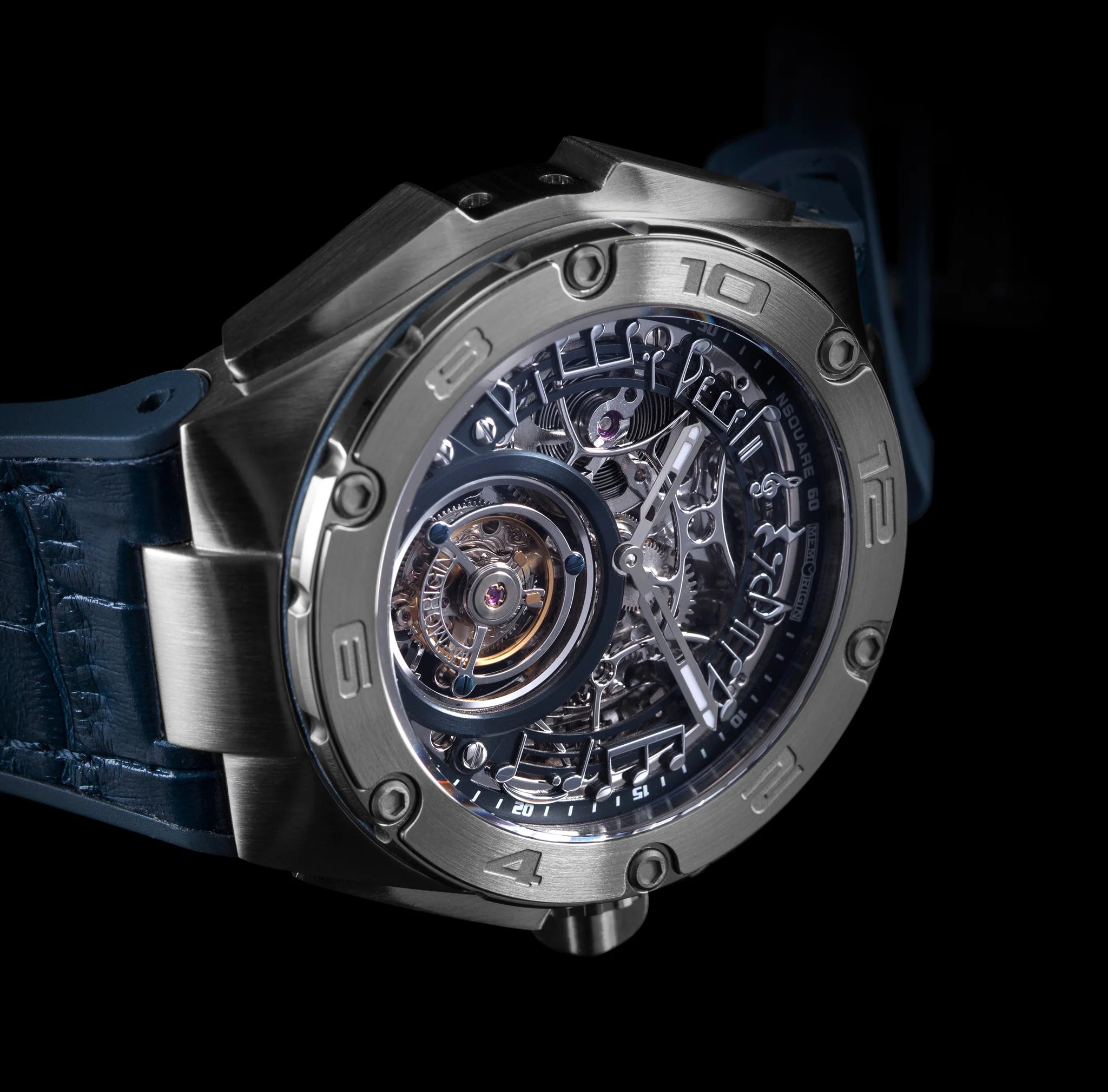 Close-up of a silver Tourbillon watch with a blue strap on a black background