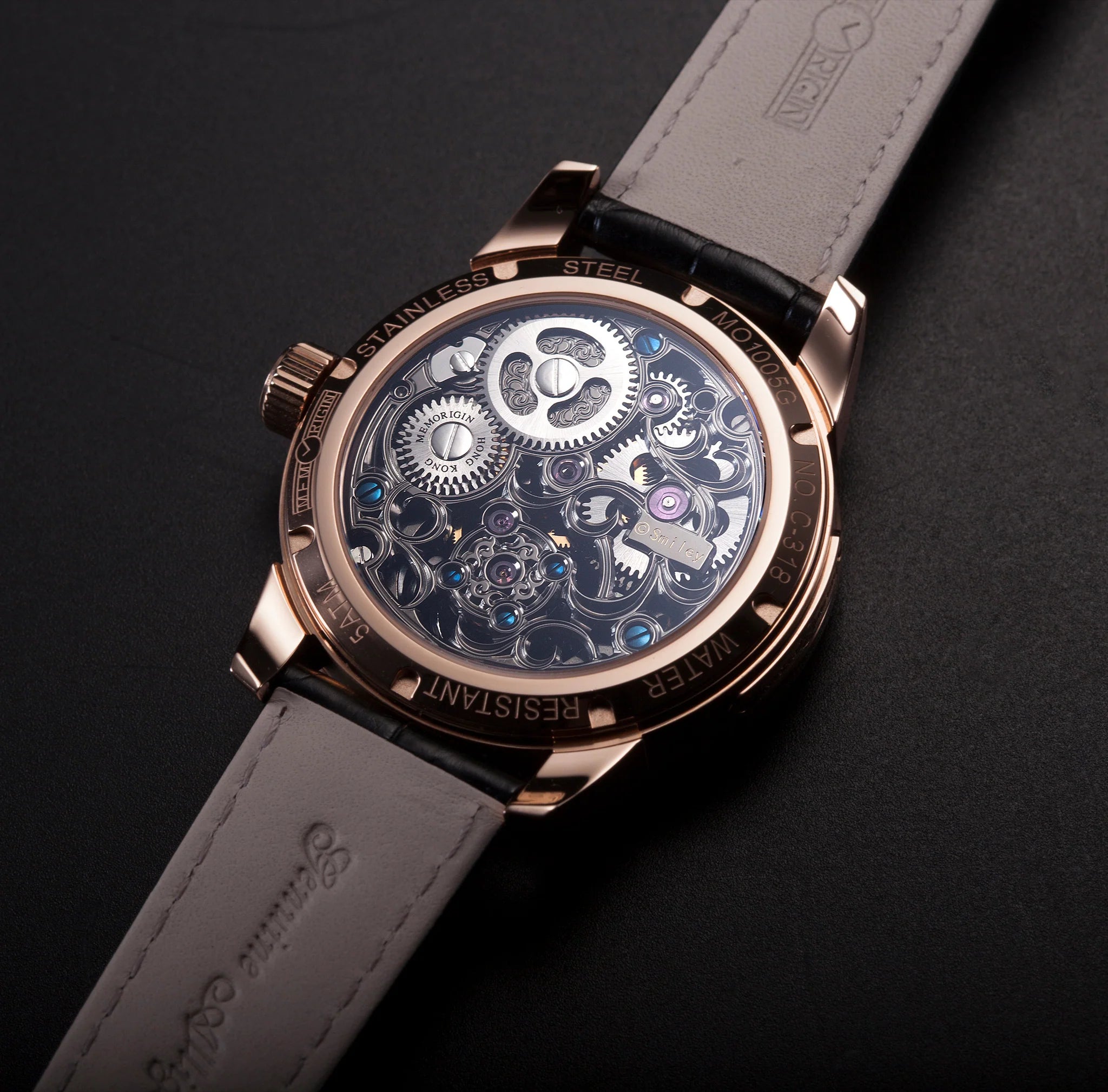 Luxury watch with visible mechanical components on a dark background