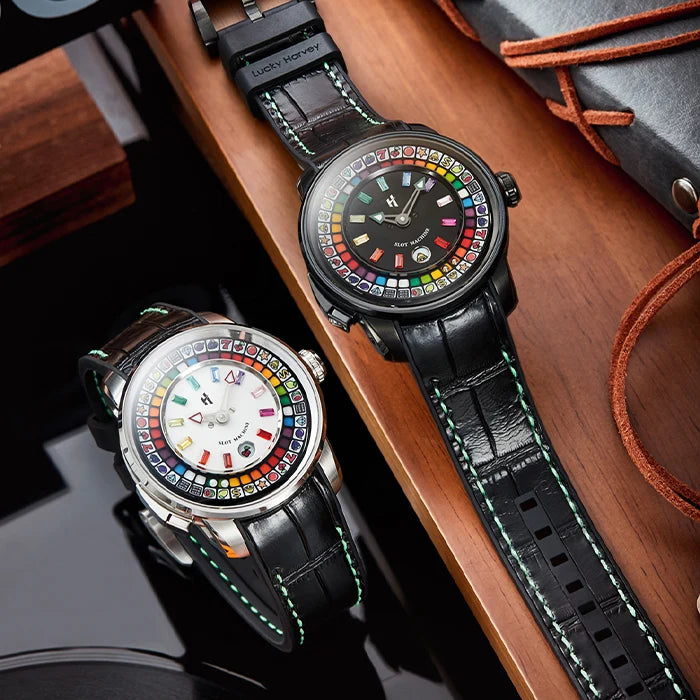 Two watches with colorful face designs on a wooden surface