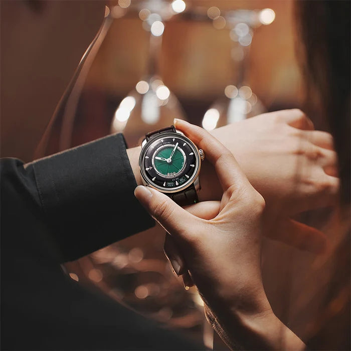 Close-up of a person adjusting a green wristwatch with a blurred background