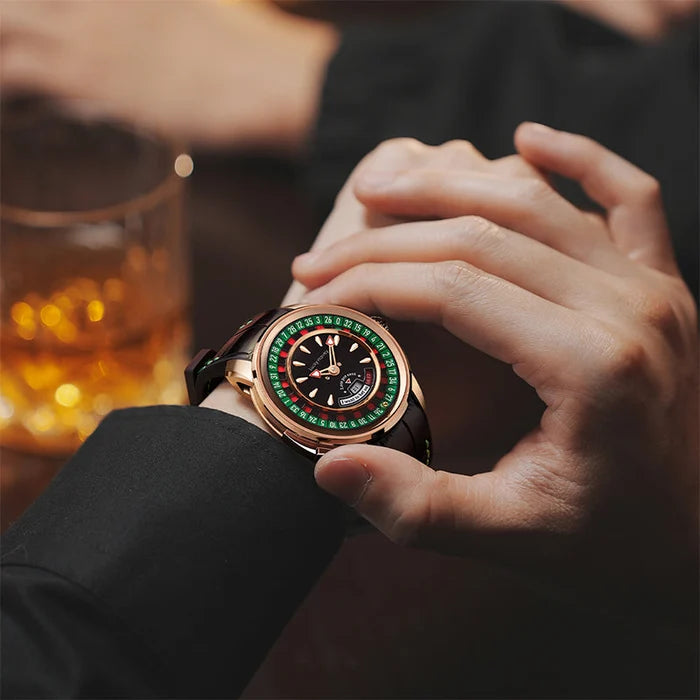 Person wearing a rose gold watch with a colorful face, blurred background with a glass of whiskey.