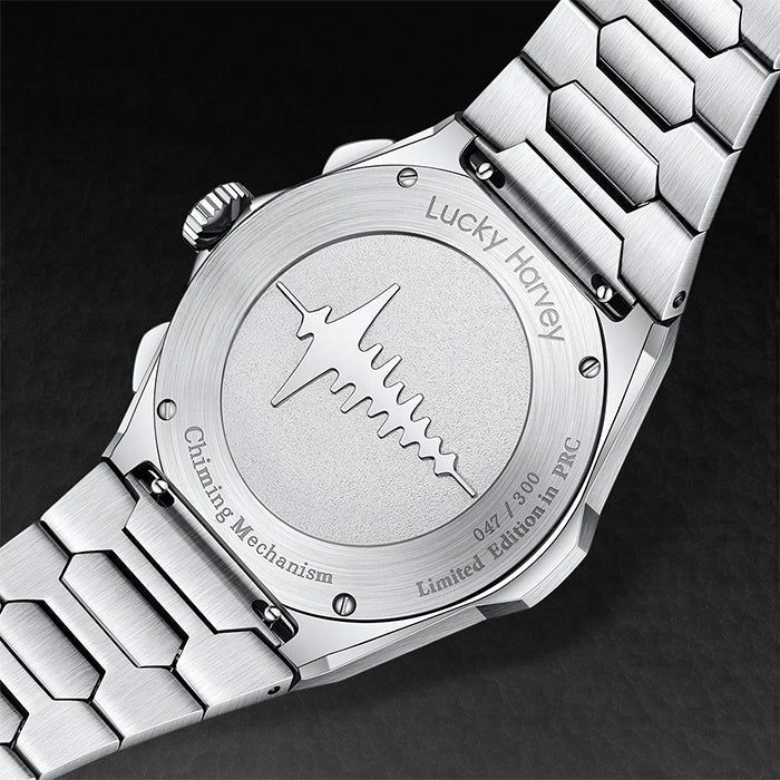Close-up of a silver watch with engraved details on a dark background