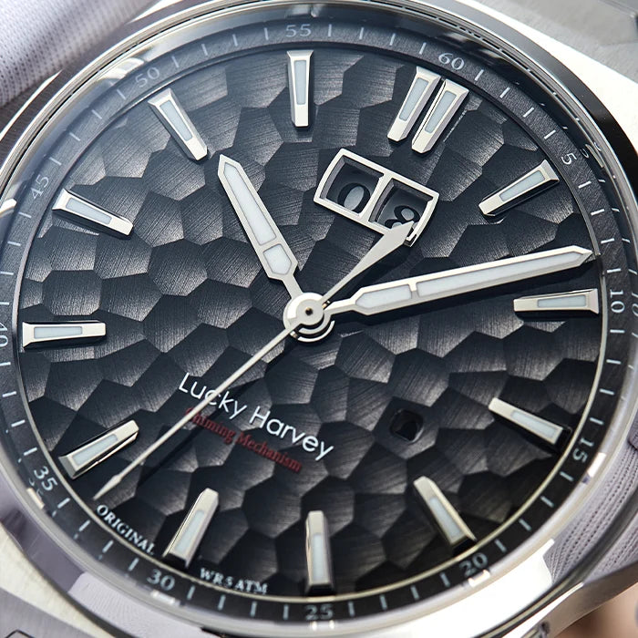 Close-up of a Lucky Harvey watch with a textured black face and silver accents.