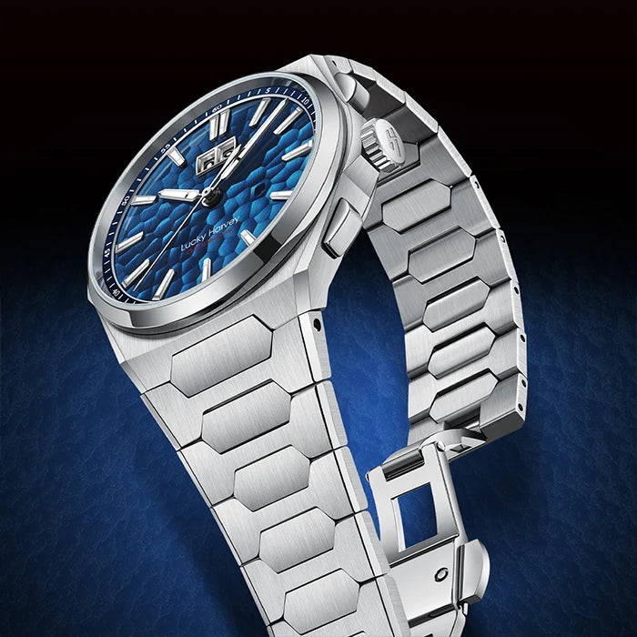 A luxury stainless steel watch with a textured blue dial and a matching silver link bracelet, shown at an angle against a dark blue and black gradient background.