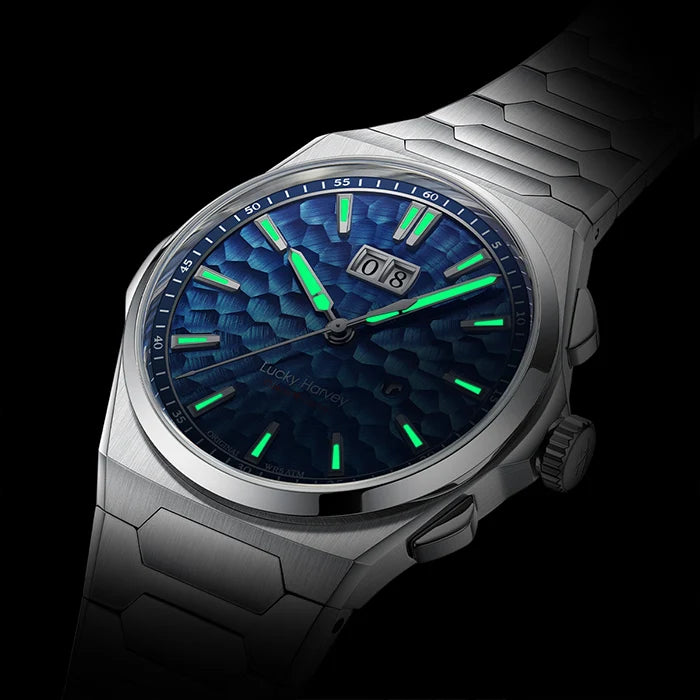 Silver watch with a blue face and green accents on a black background