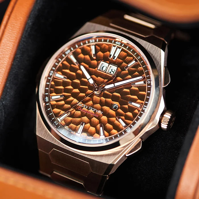 Luxury watch with brown textured dial and silver case in a box