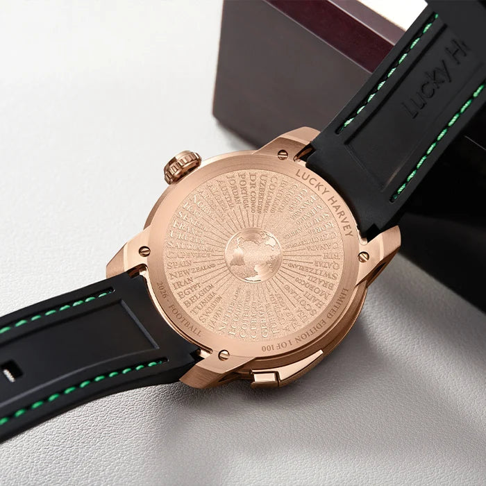 Luxury watch with rose gold case and black strap on a light gray background