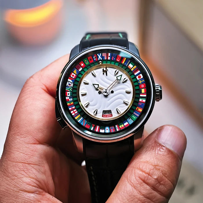 Hand holding a watch with a colorful face featuring international flags.