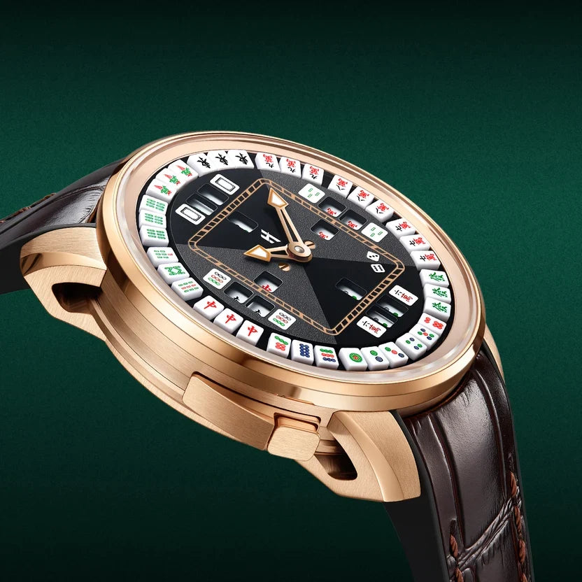 A luxury watch featuring a gold-tone case, a black dial with a roulette-style layout of playing cards, and a dark brown leather strap, shown against a dark green background.