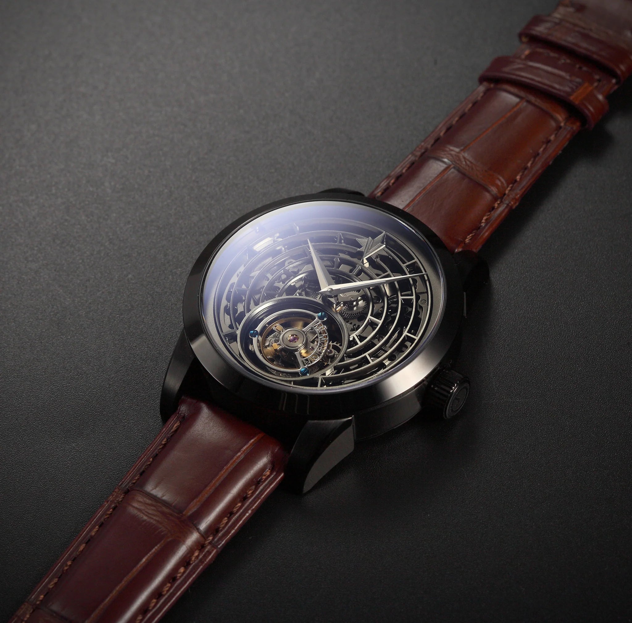 Luxury watch with brown leather strap on a dark background
