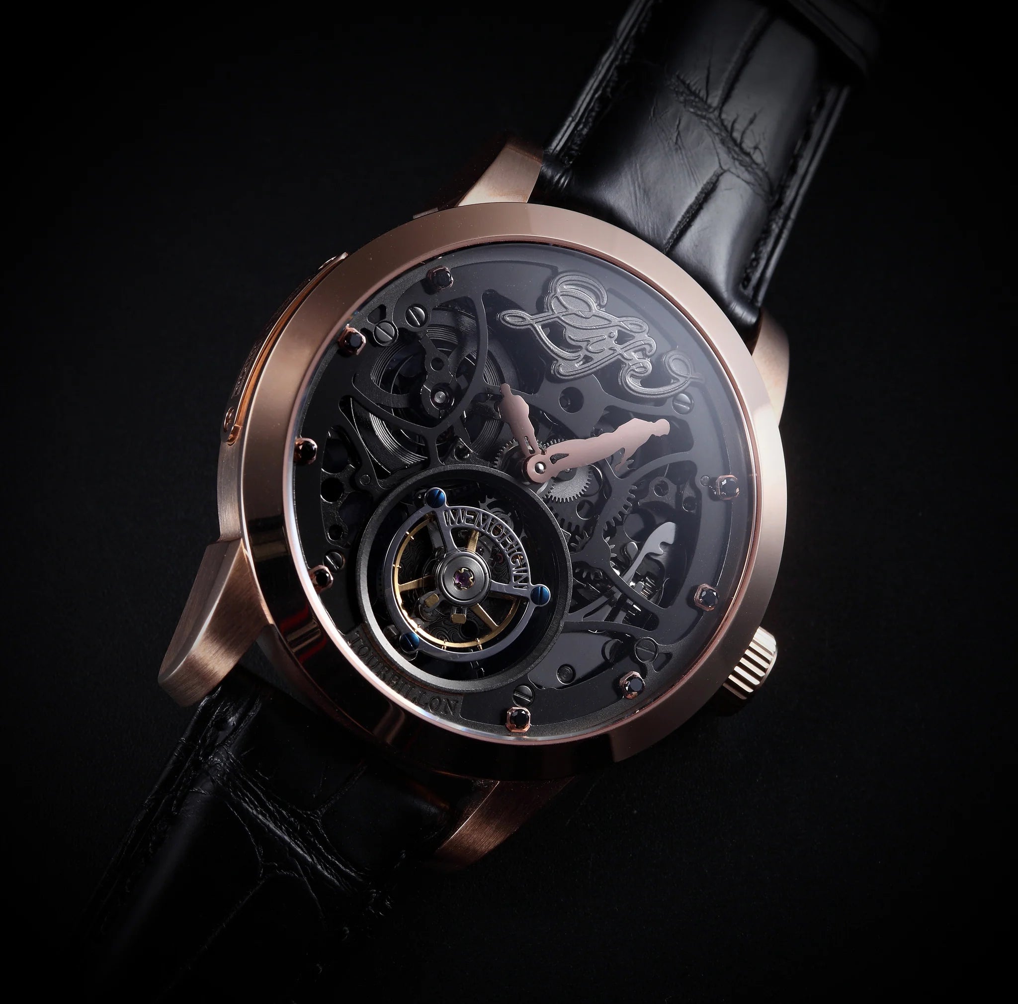 Luxury watch with black leather strap and intricate design on a dark background