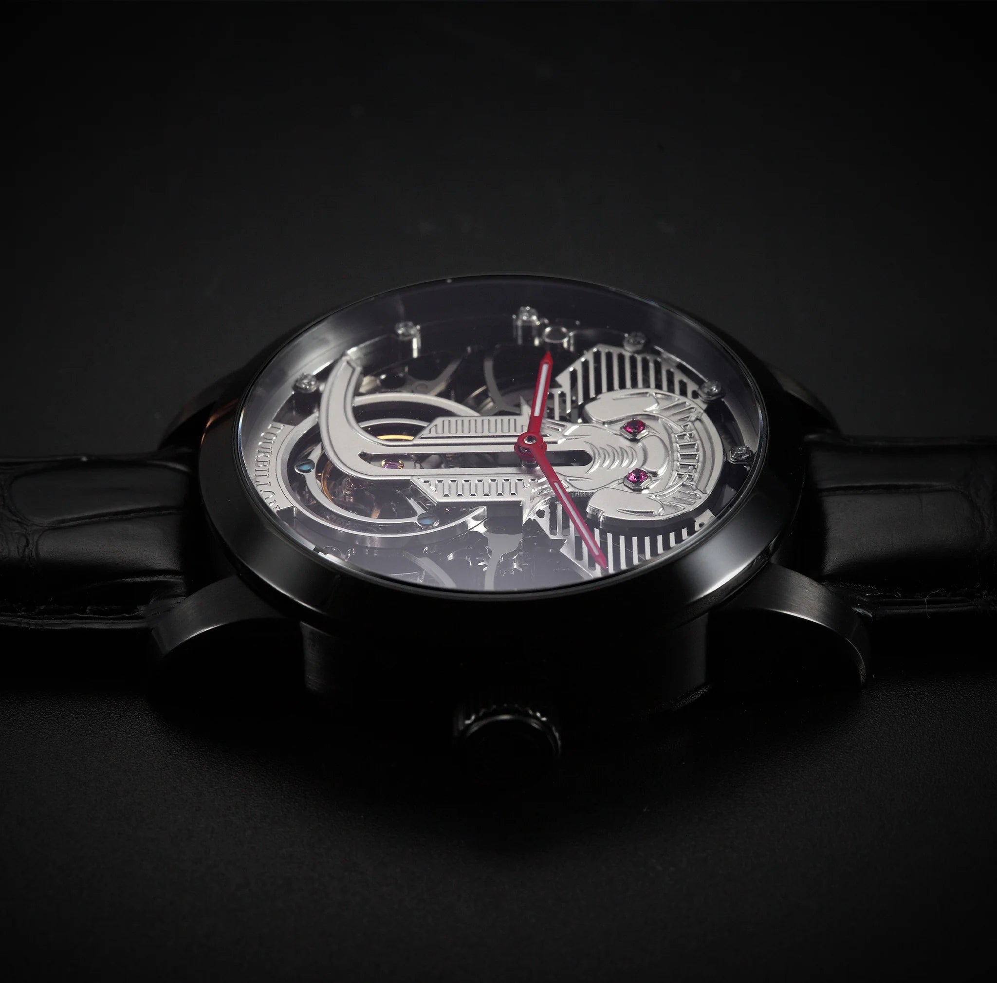 Black wristwatch with intricate design on a dark background