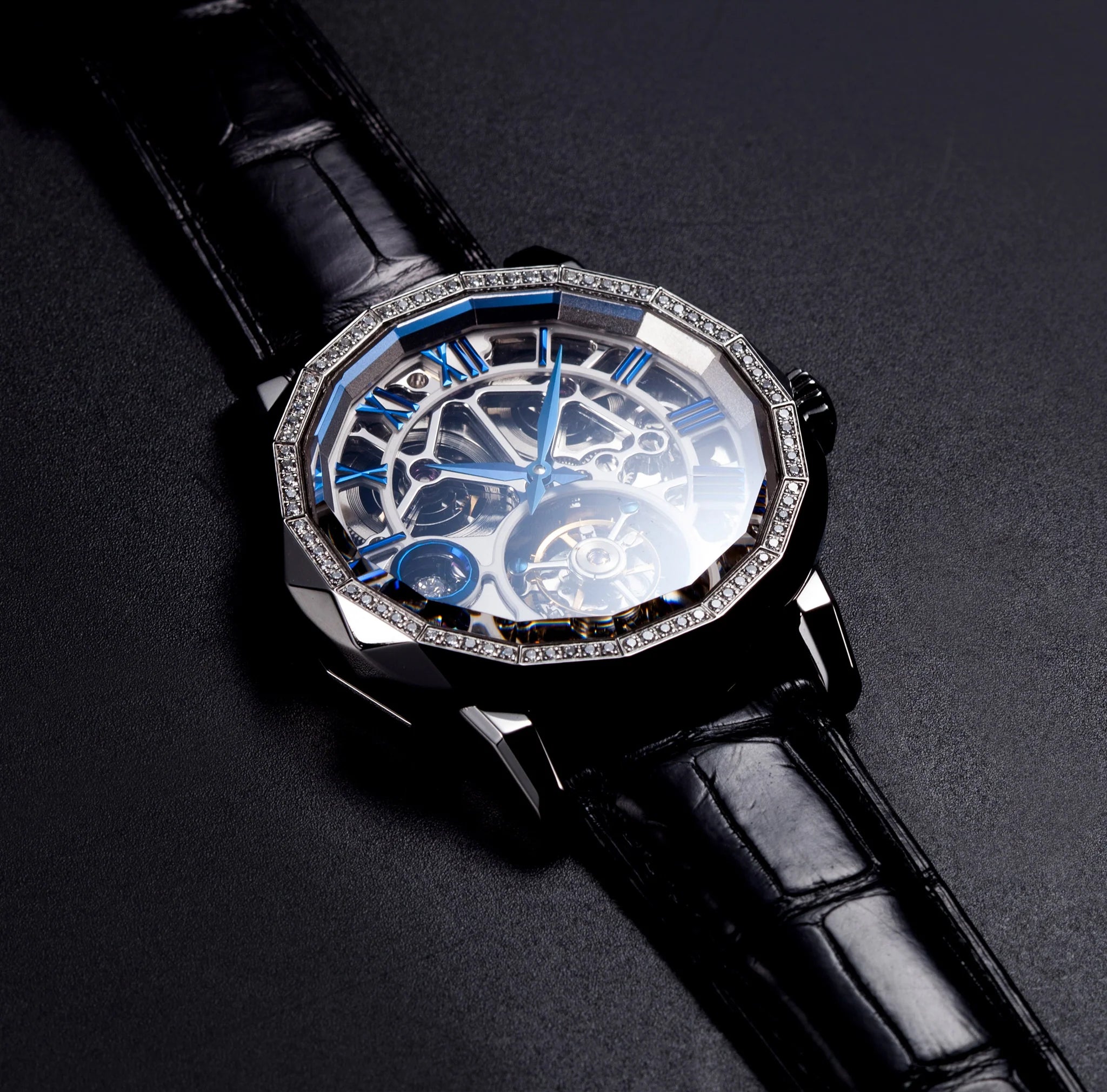 Luxury watch with black leather strap and transparent face on a dark background