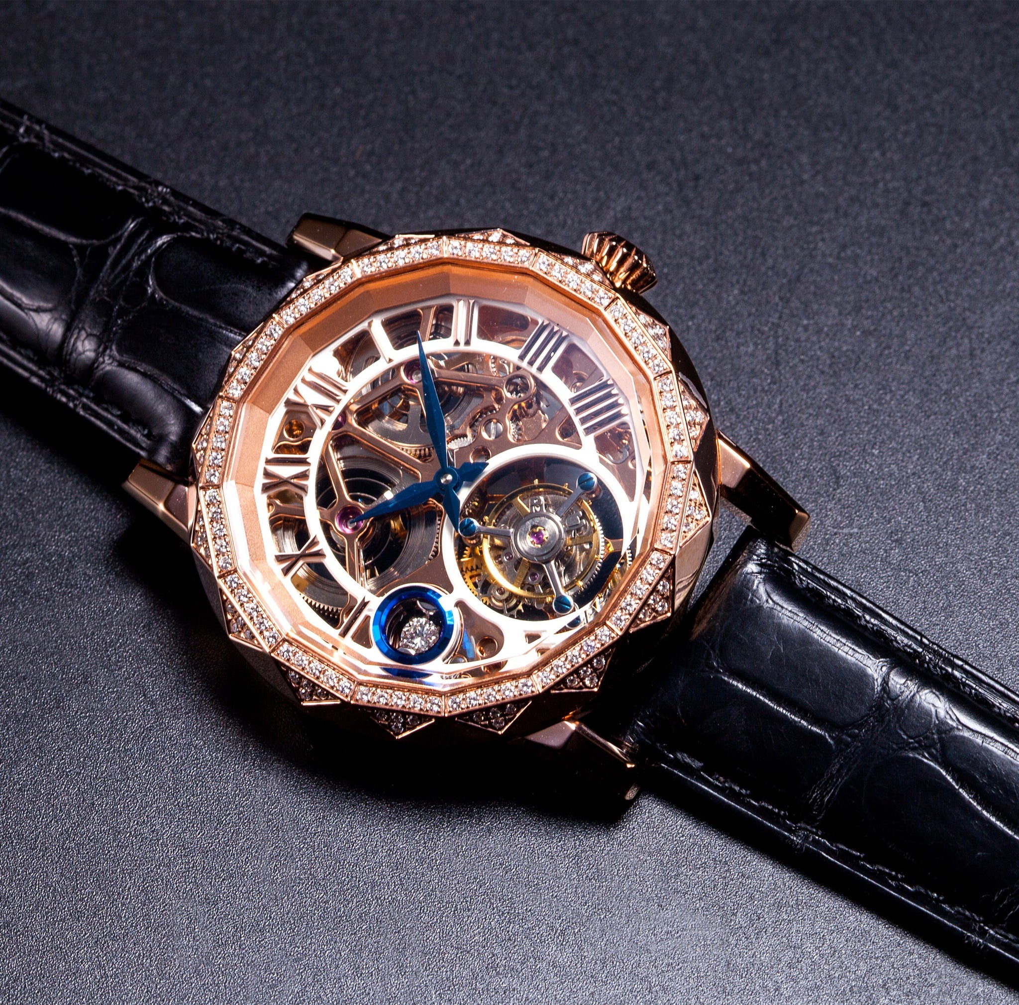 Luxury watch with black strap and rose gold case on a dark background