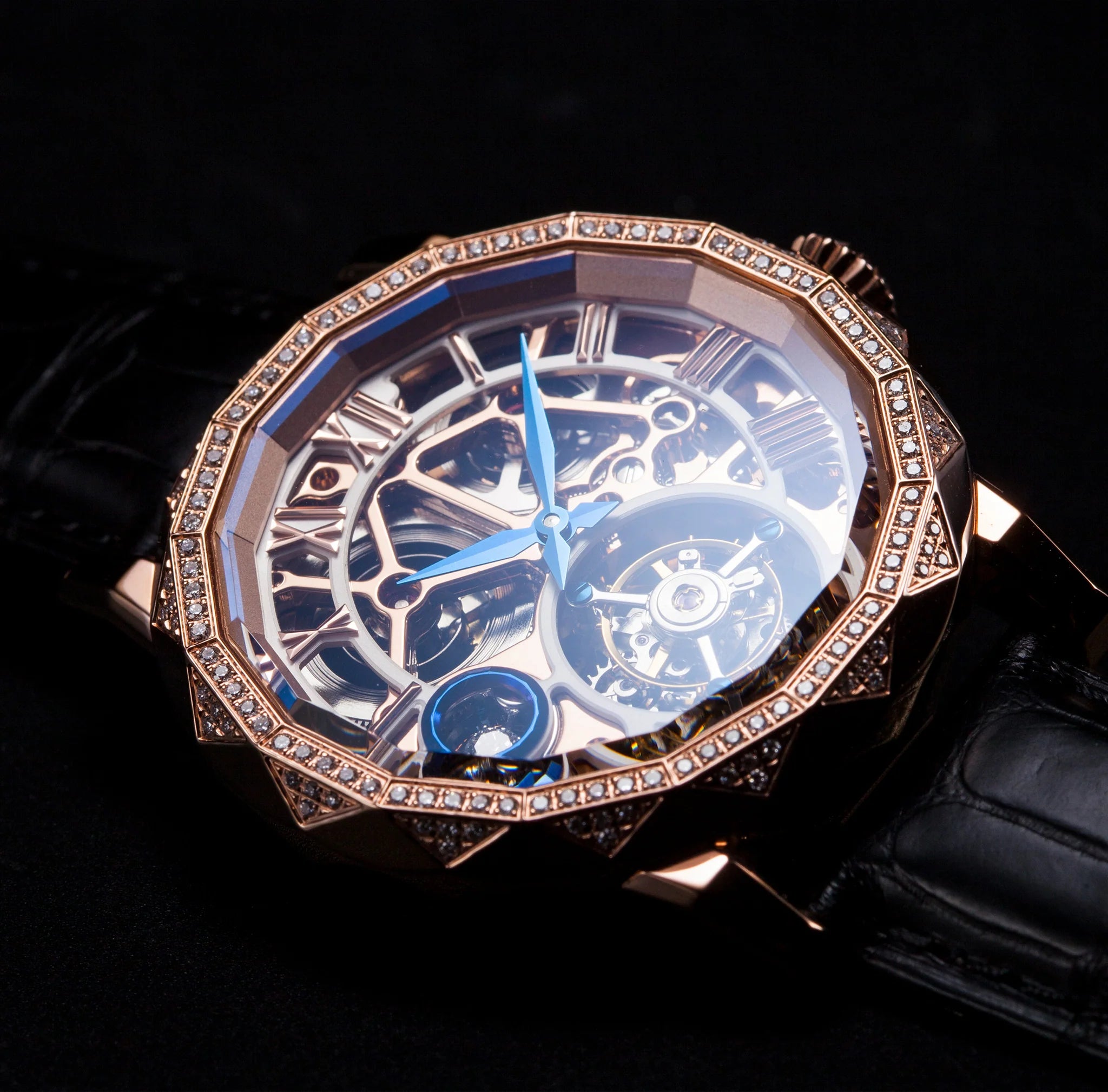 Luxury watch with intricate design and rose gold bezel on a black background