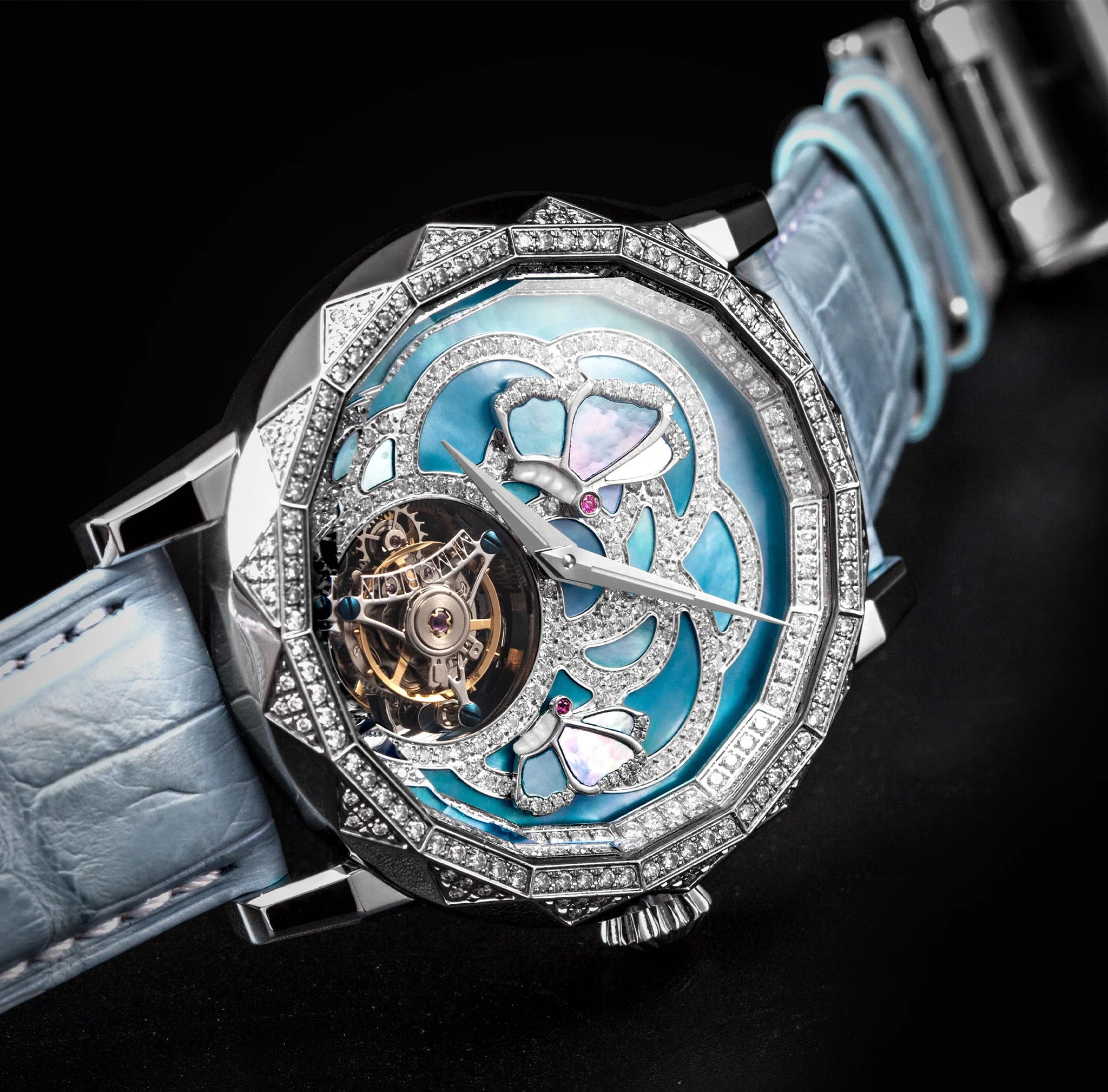 Luxury watch with intricate design and blue strap on a dark background