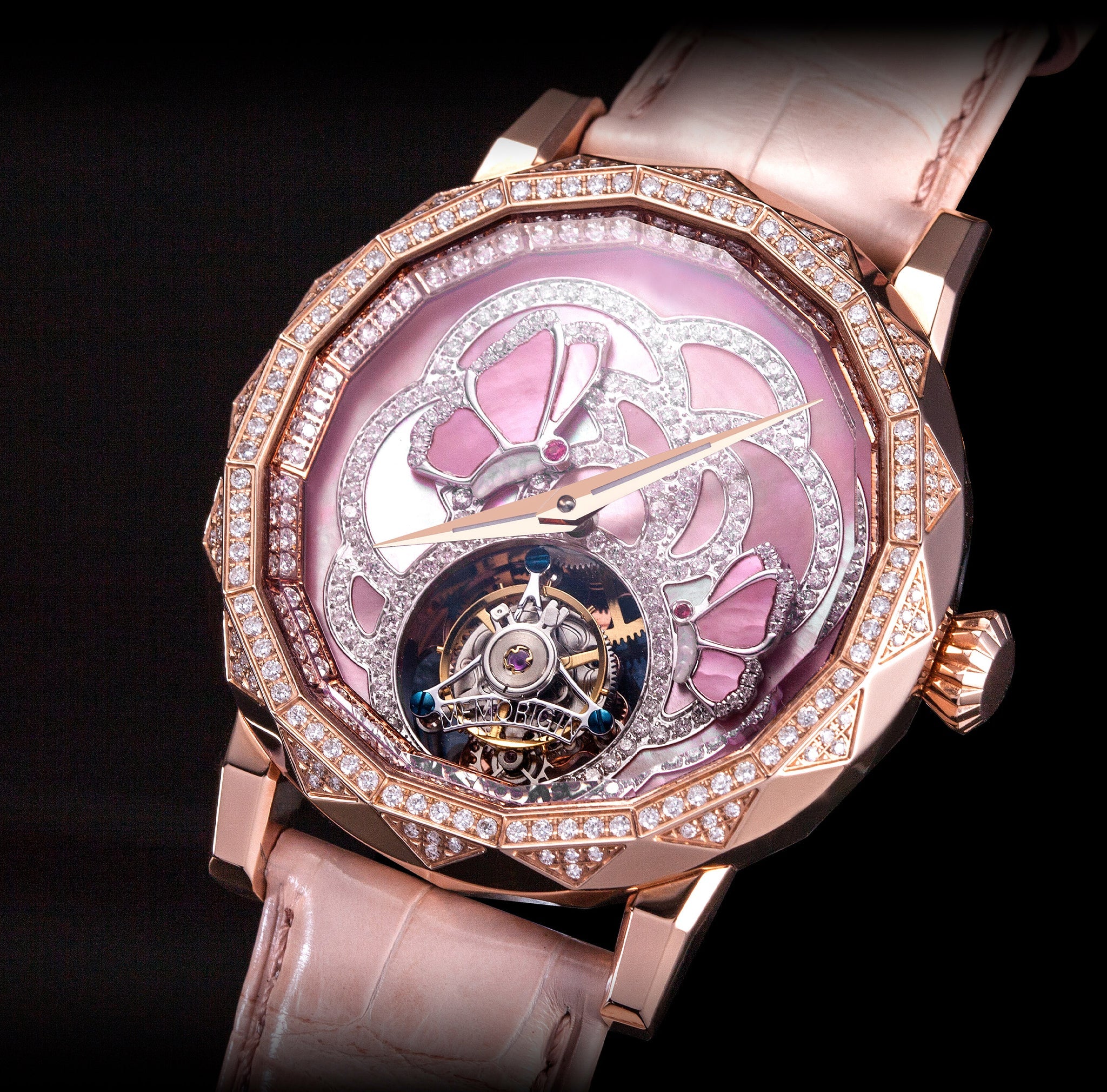 Luxury watch with pink face and rose gold case on black background