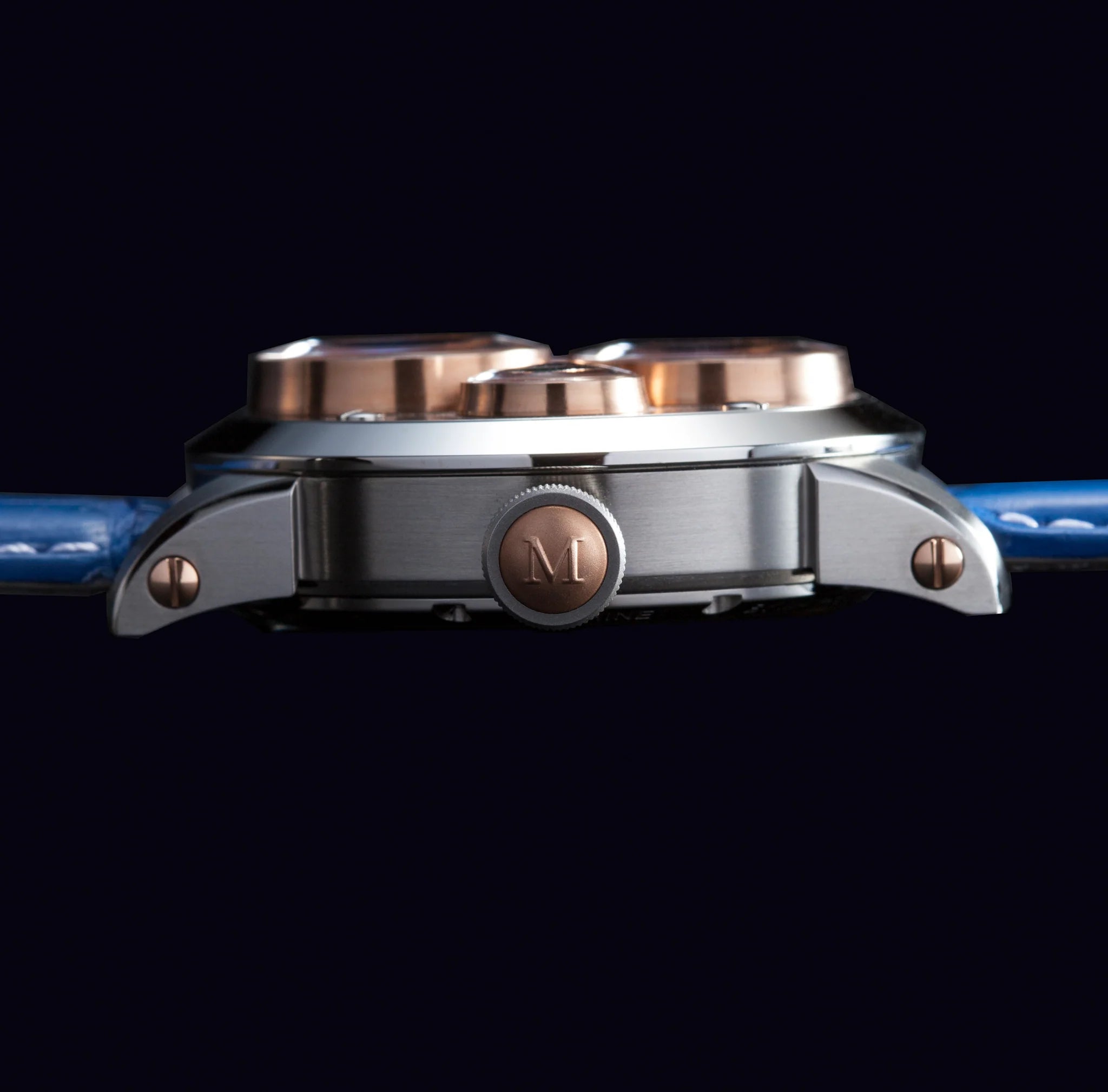 Close-up of a watch with metallic and blue design on a black background