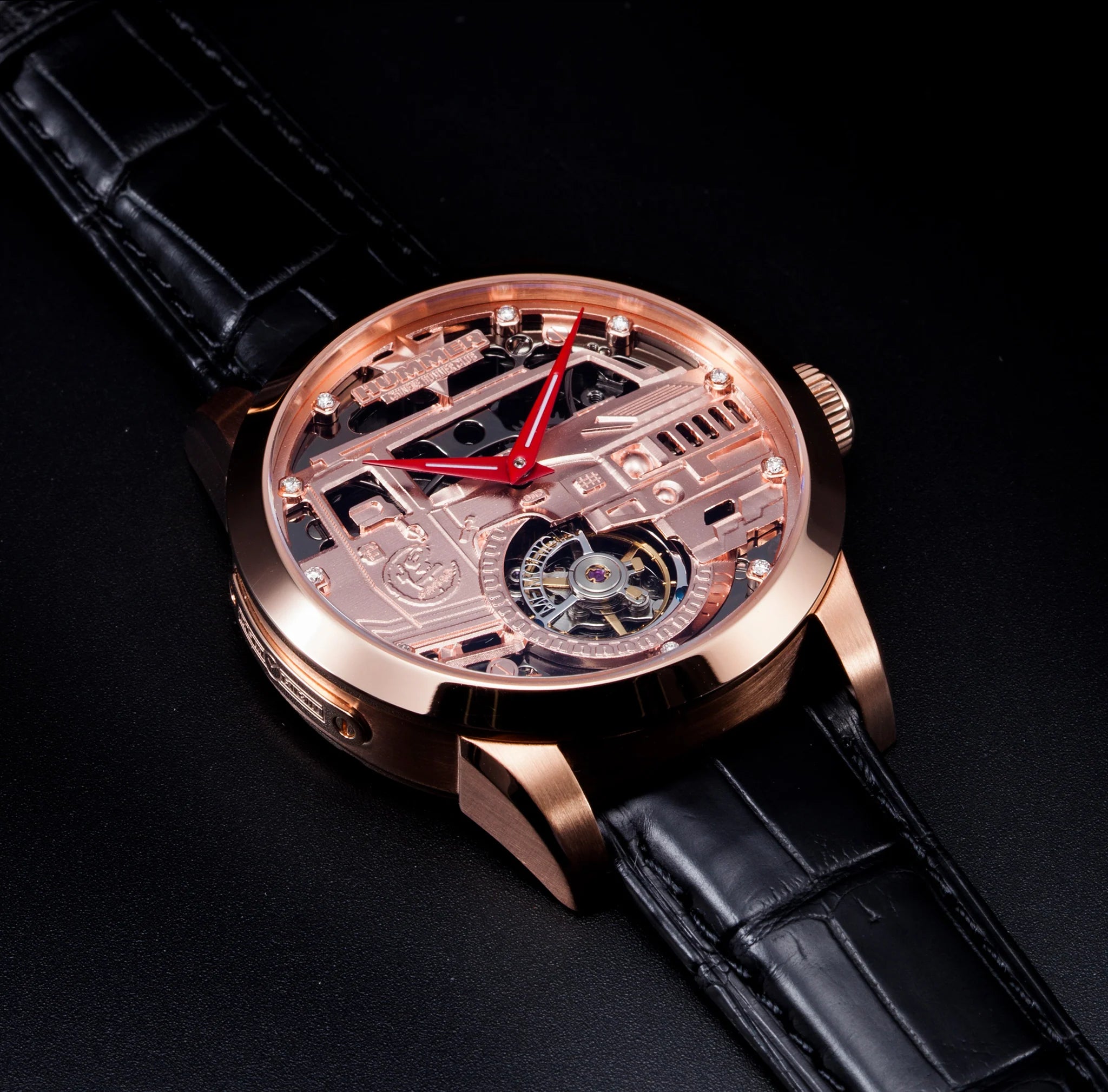 Luxury watch with black leather strap and rose gold case on a dark background
