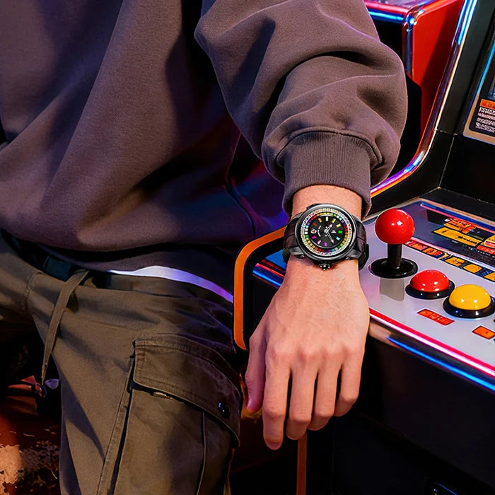 Person playing an arcade game with a colorful watch on wrist