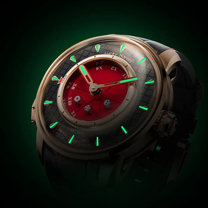 Luxury watch with red face and green accents on a dark background