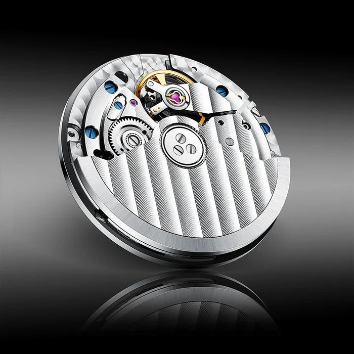 Close-up of a mechanical watch movement on a reflective surface with a dark background