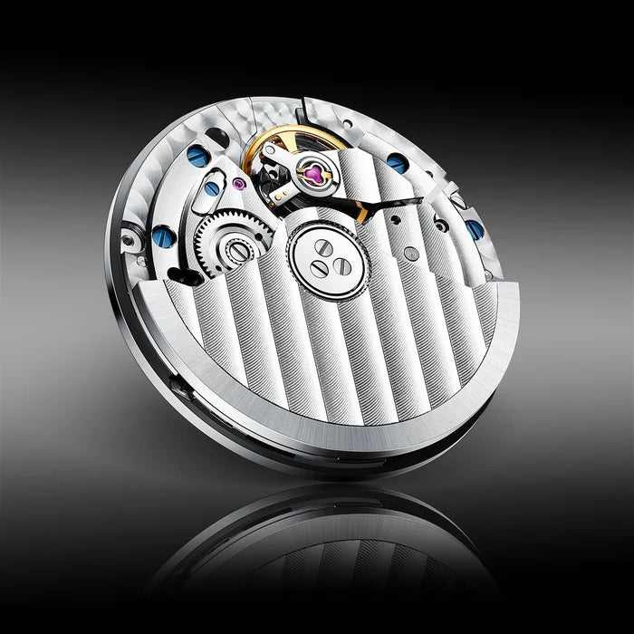 Close-up of a mechanical watch movement on a reflective surface with a dark background