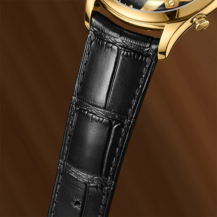 Close-up of a gold watch with a black leather strap on a brown background