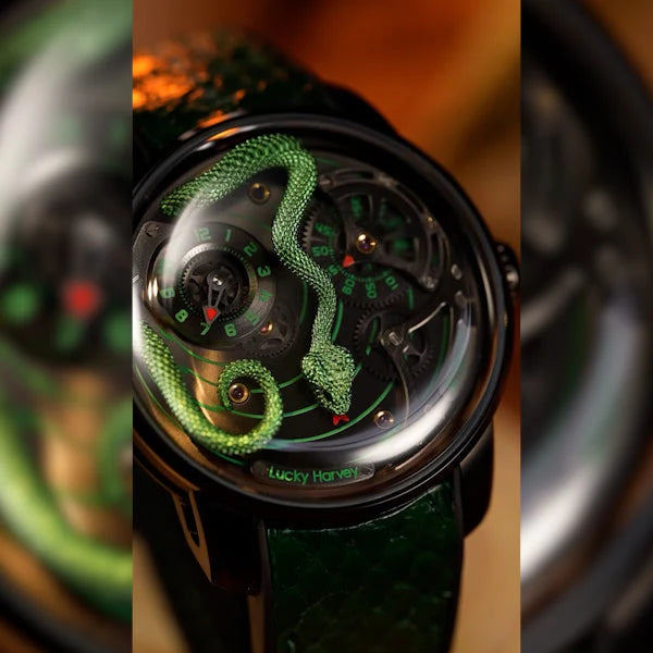 Luxury watch with green snake design on a dark background