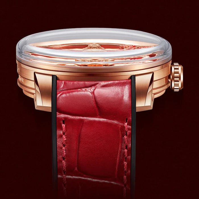 Luxury watch with rose gold case and red leather strap on a dark background