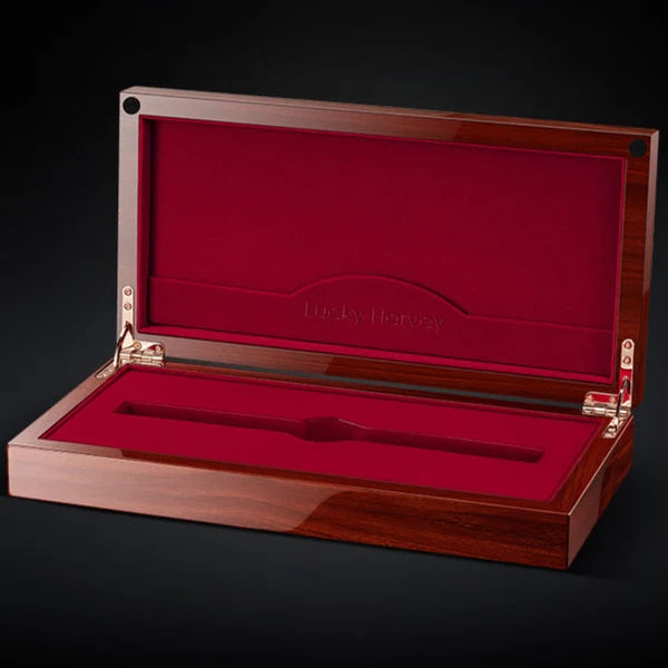 Wooden jewelry box with red interior on a black background