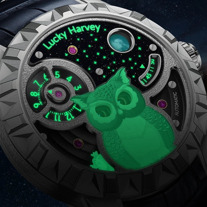 Close-up of a watch with a green owl design and 'Lucky Harvey' branding.