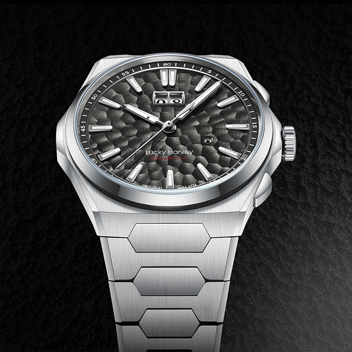 Silver watch with a textured black dial on a dark background