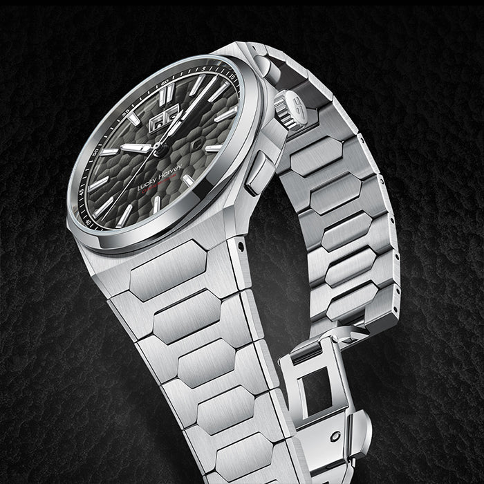 Silver watch with a detailed face on a dark textured background
