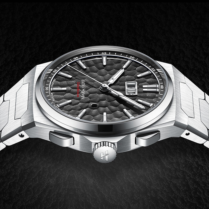 Silver watch with detailed face on a dark background