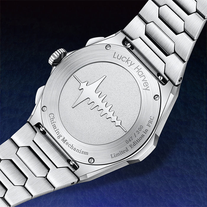 Close-up of a silver watch with engraved details on a dark background