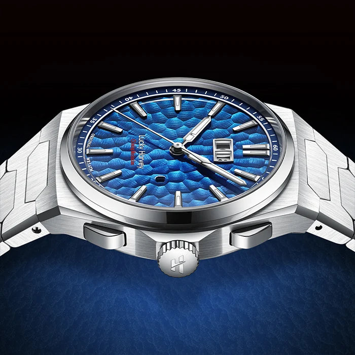 Silver watch with blue face on a dark background
