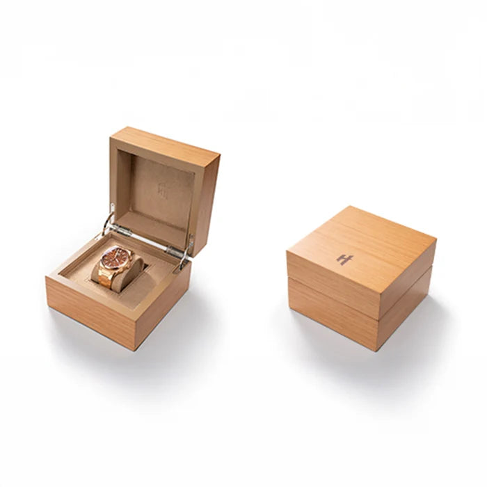 Wooden jewelry box with a watch inside on a white background