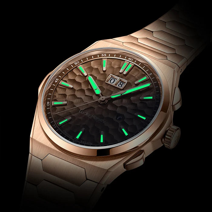 Luxury watch with green glowing hands on a dark background