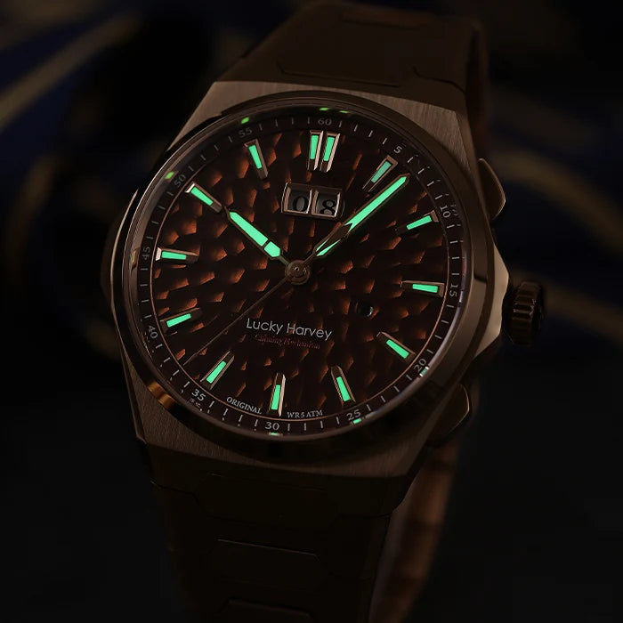A Lucky Harvey chronograph watch with a dark textured dial and bright green luminescent markers, shown in low light against a dark background.