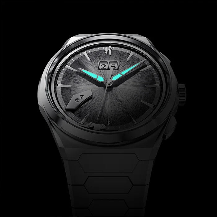 A dark gray and black analog watch with glowing turquoise hands and date windows, shown against a solid black background.