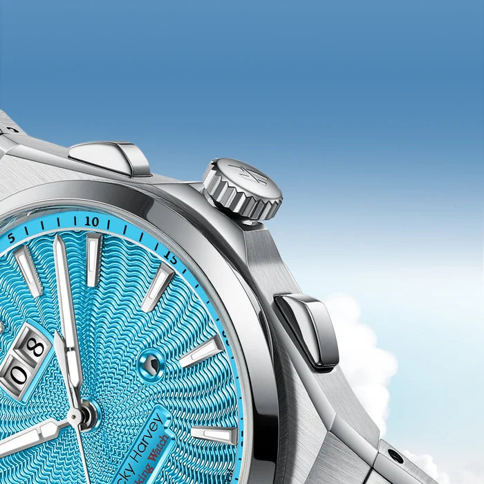 Silver watch with a blue face against a clear blue sky