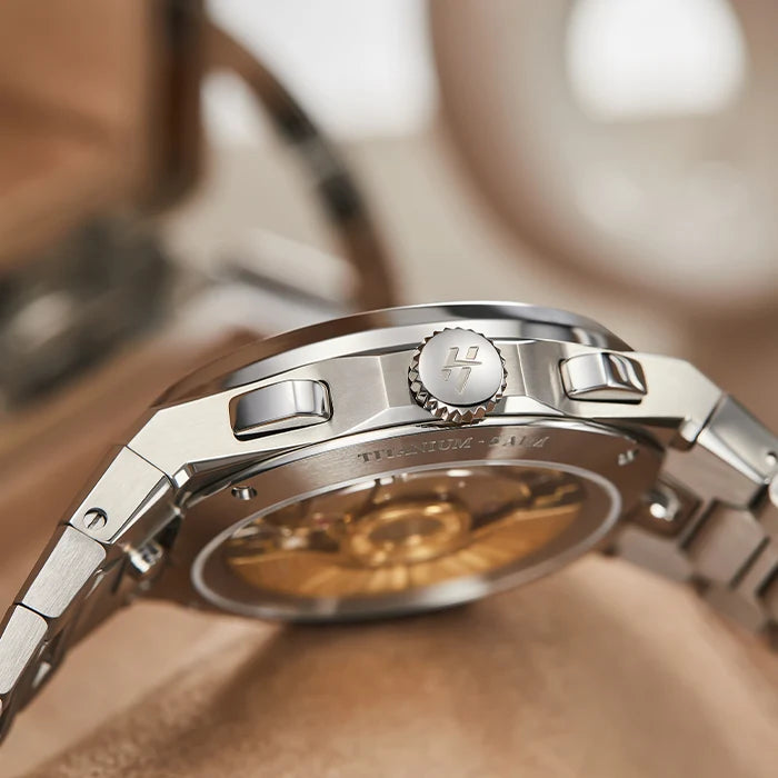Close-up of a silver watch with a blurred background