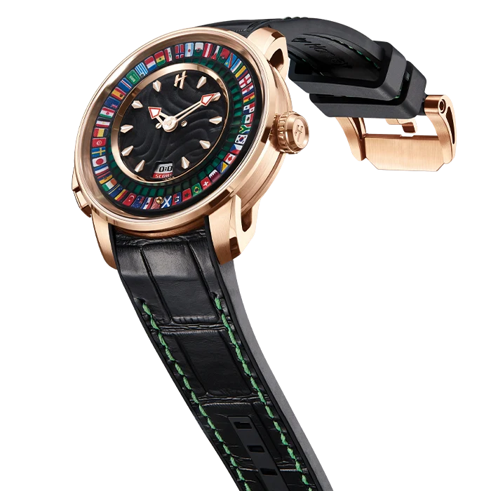 A luxury wristwatch with a rose gold case, a black dial featuring a colorful ring of international flag icons, and a black alligator leather strap with green stitching, shown on a white background.