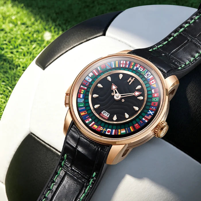 Luxury watch with a colorful dial on a soccer ball against a grass background