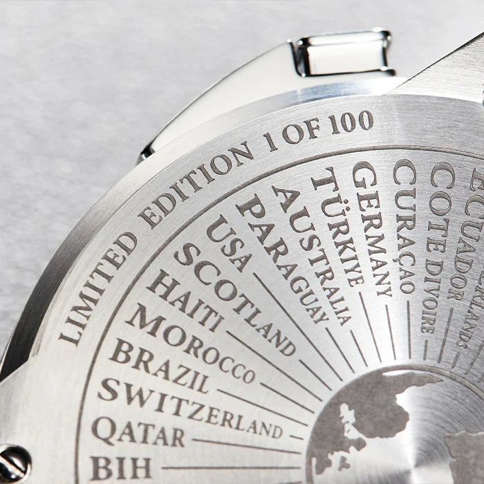 Close-up of a silver stainless steel watch case back featuring an engraved world map and a limited edition counter, with country names including USA, Australia, Germany, and Switzerland.